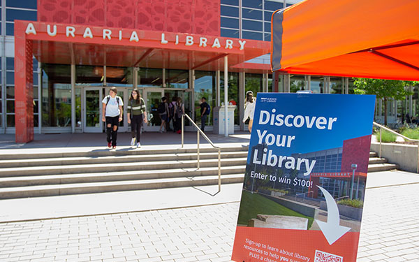 a sign that says Discover Your Library posted outside the Auraria Library