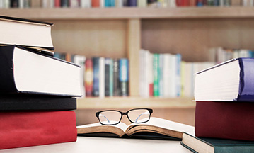 eye glasses resting on books