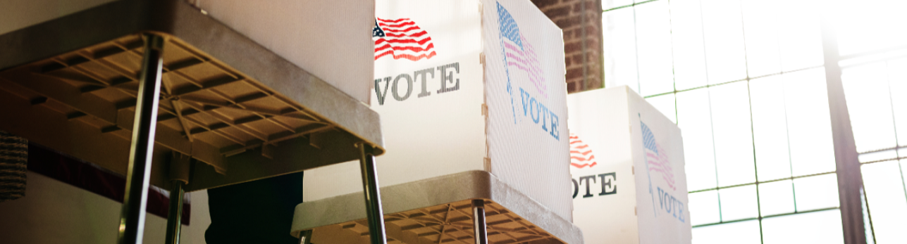 voting box adorned in American flag with text Vote