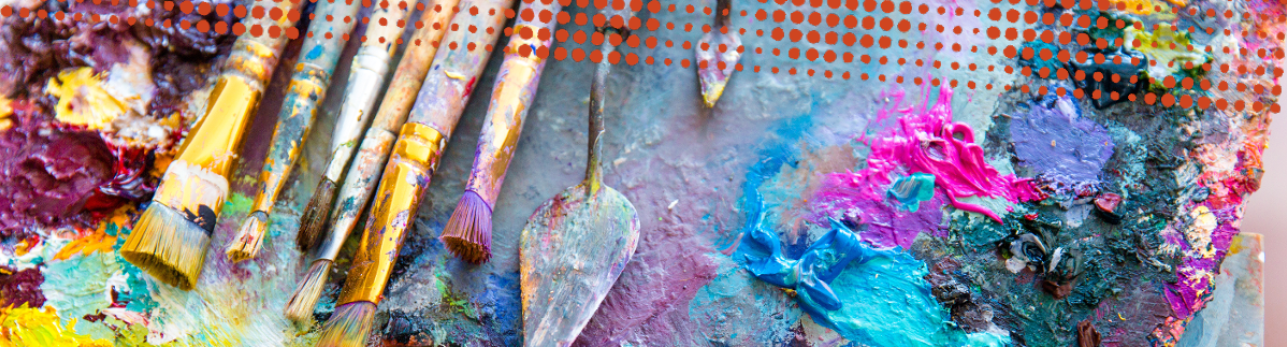 A palette with various colors of paint and paintbrushes.
