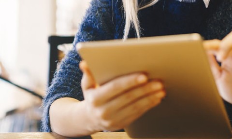 student using a tablet in a library