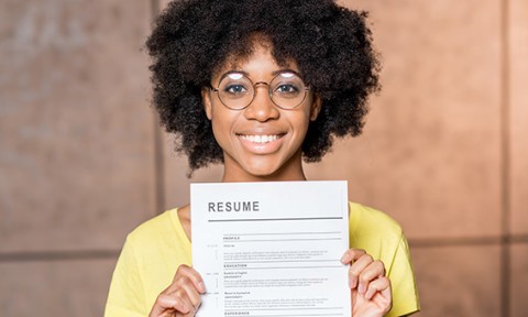 Adobe Stock By rh2010 Portrait of a young african woman holding resume document indoors