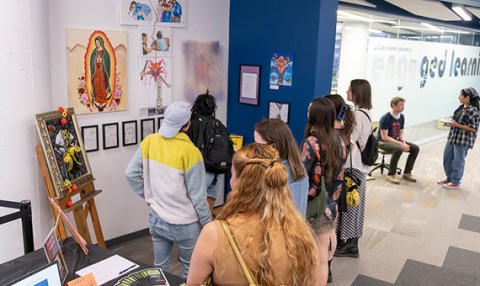 Attendees explore student art about immigration