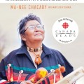 Cover of "A Two-Spirit Journey" showing an Indigenous elder, in traditional attire, joyfully playing a drum. The book is a winner of Canada Reads 2025.