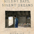 Cover of the book "Silent Days, Silent Dreams" by Allen Say, featuring a boy looking out of a window in a wooden building, with various colorful drawings displayed on the floor.