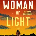 Book cover for "Woman of Light" by Kali Fajardo-Anstine, featuring a silhouette of a woman on horseback against a vibrant orange sunset with mountains.